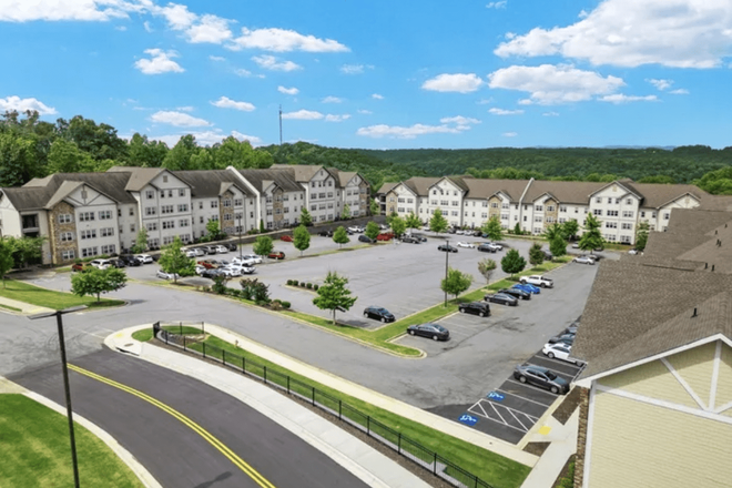 Parking lot. Your building is the one on the right at the very end. - Bellamy Apartments 4x4L