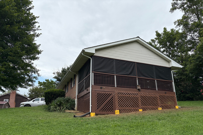 Downhill view of screened deck - House with river view