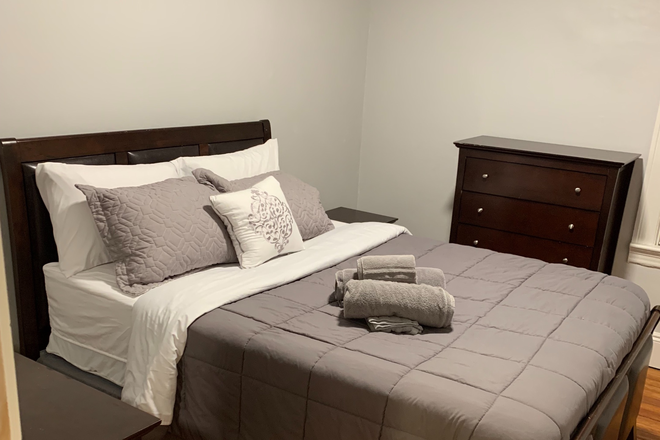 bedroom with sheets and towels - Everything included modern apartment