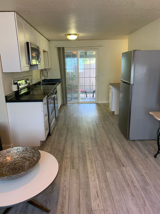 First floor, view to slider to backyard - Close-In, Sunny, Pet-friendly, 2-bedroom with Yard, and a 9-month Lease! Duplex