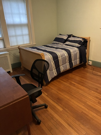 Primary bedroom and desk - Primary Bedroom in Coolidge Corner condo with beautiful courtyard