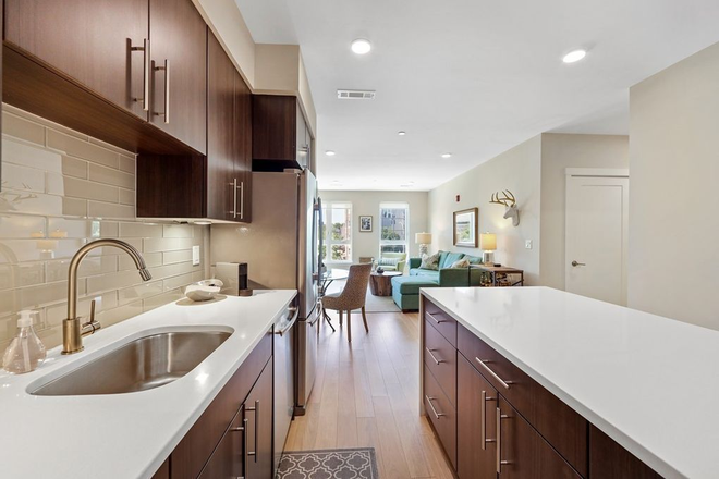 Kitchen with Quartz Counters & Island - All the Perks! Sunny 2BR/2BA Condo with In-Unit Washer/Dryer, Covered Parking & Near Porter Sq!