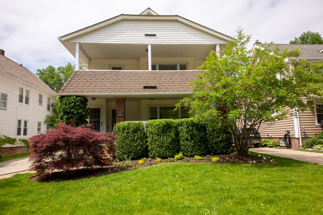 Charming Cleveland Heights duplex featuring classic architectural character, mature landscaping, and an inviting covered front porch - Easy access to healthcare and academic institutions. RTA bus routes and the Health Line Transit.