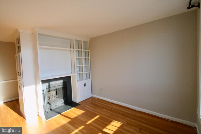 Living room with built ins, fireplace - Charming Two Bedroom Condo Conveniently Located in the Heart of Glover Park