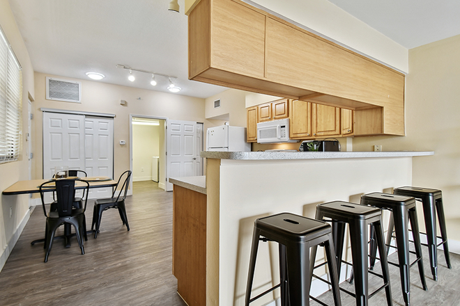 large, open design, garbage disposal, dining table and chairs, procelain tile, hardwood cabinets - Malibu Apartments 4Bed/4Bath