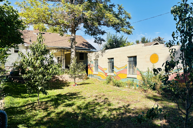 Back of the home with detached garage space for you - Cozy Garden-Level Apartment