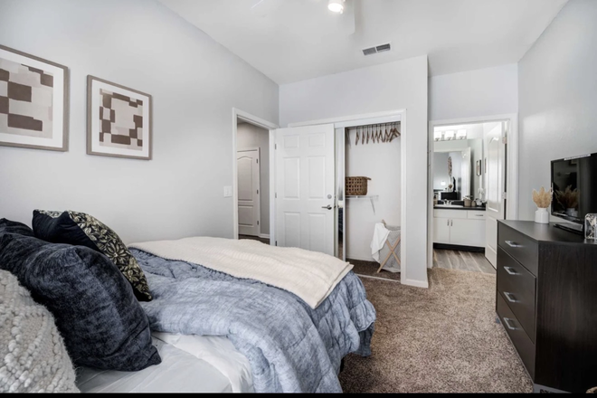 Bedroom view two; attached bathroom, spacious closet with large full-body mirror - The Lodge on the Trail Apartments