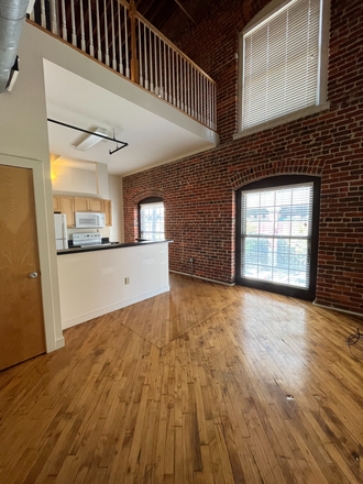 #202 - living room (1st angle) w/ loft view above - Big or Small, We’ve Got It All – 1 & 3-Bedroom Apartments Waiting!