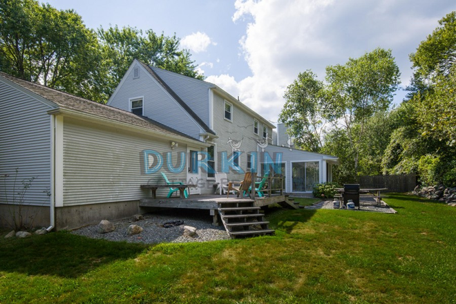 Back view - Eastward Look Contemporary Home with Open Living Spaces, Deck, and Patio Areas