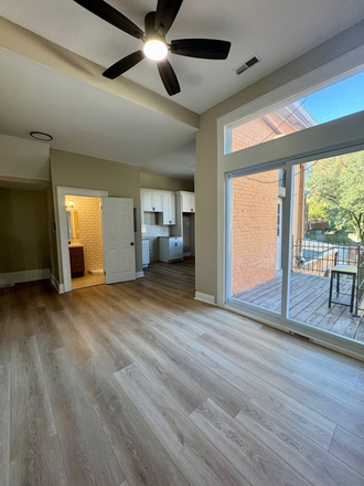 Spacious and open concept living area with walk out to courtyard - Renovated 2 bedroom in OTR Condo