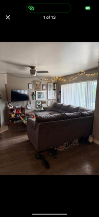 living room with couch and mounted TV - Valencia Gardens Apartment. FIRST MONTHS RENT FREE! option for couch, queen bed, mounted TV