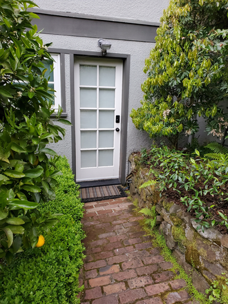 Front door with smart lock and overhead automatic light - Gorgeous furnished newly remodelled studio apartment with same floor shared laundry.