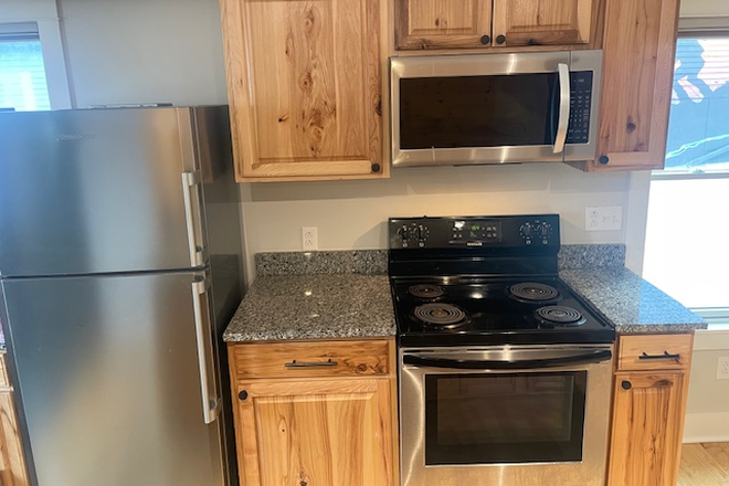 View of kitchen stove & microwave after fridge. Picture  from Granite breakfast bar - 2 Bedroom, 1st floor apartment at 149a Pine St.