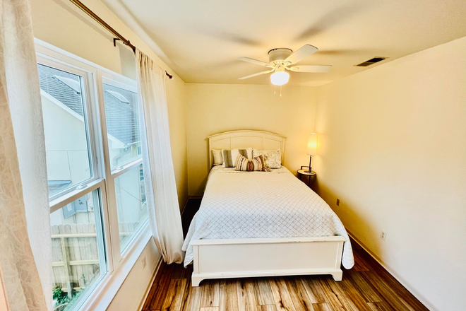 Bedroom showing a large window facing the driveway - Bike to Rice 1b1b "Fully Furnished All bills included Fully Equipped" Apartments