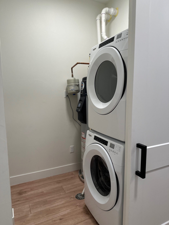 In unit laundry also has shelving/closet racks - Across the street from Regis University Newer  Zen condo