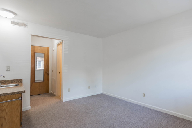 A door to the living room/kitchen, a decent-sized closet on the left, and a bathroom on the right. - Graduate Centre (27 days free rent in May!) Apartments