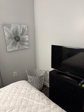 TV and Clothes Hamper in room - Room for Rent with Shared Bathroom Townhome