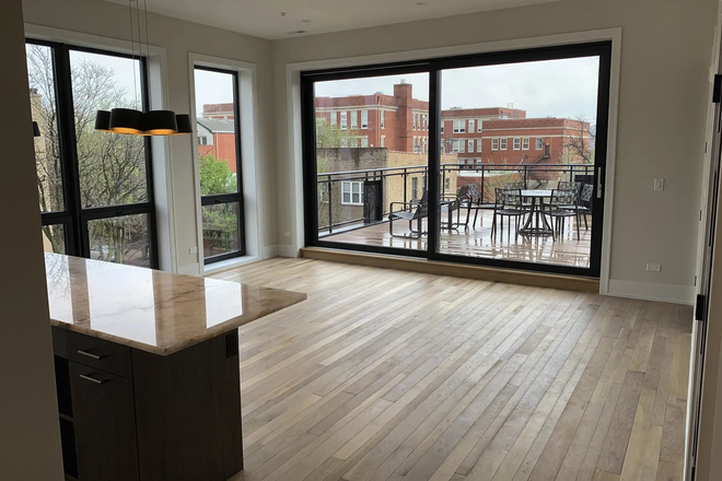 living room and deck - 4 Bedroom gorgeous one-of-a-kind apartments within minutes of UIC east campus.