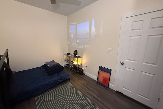 Bedroom (projector on) - 55-59 Burbank St LLC Apartments