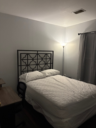 Full Size bed with Headboard with Blinds and curtains on the window - Room for Rent with Shared Bathroom