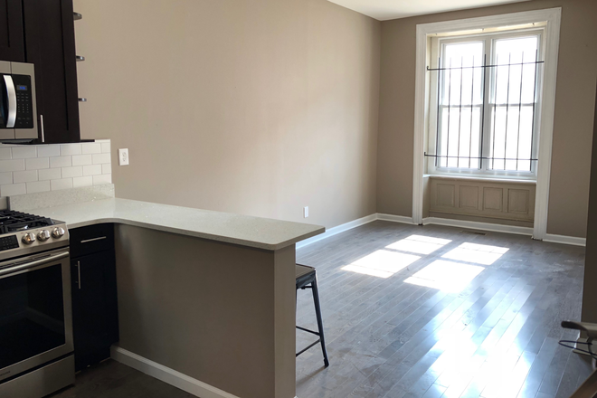 Living Room - OCP - Updated Unit With Private Patio On Best Off Campus Block - 4 Bed 2 Bath Apartments