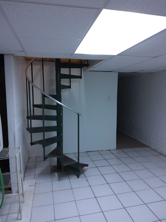 Spiral stairs to lower level - 2-bedroom apartment located just south of Charles Village