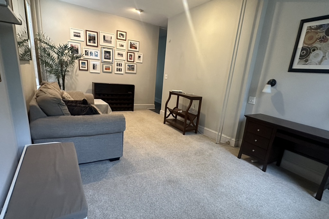 Living room with queen pull-out couch, desk, bookshelf, wine rack - Furnished 1BR Condo-Park Place-Princeton