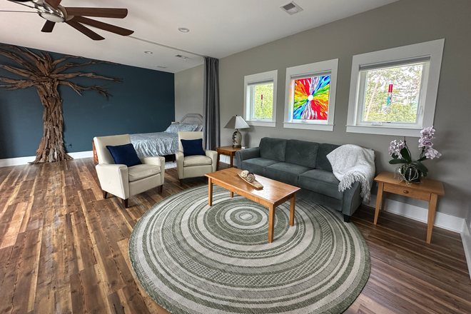 Living room with bedroom partition open - Modern Lakeview Studio / Peaceful Executive Retreat near Charleston, SC