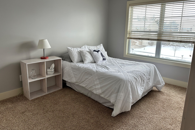 Bedroom with double bed - Room for Rent in a spacious 3000 sq ft house in Okemos, approximately 4 miles from MSU