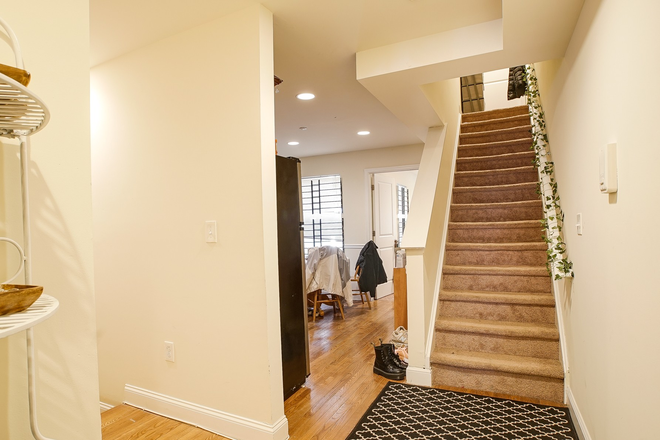 Interior stair leading to upper Floor, with dinning to the left - Gorgeous 3-level Newer Apartment 1/2 block from Temple Campus, READY FOR THE 2026-2027 SCHOOL YEAR!