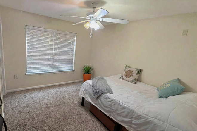 Bedroom, walk-in closet through left door not shown on the photo - Woodlands of College Station - Private room and bathroom