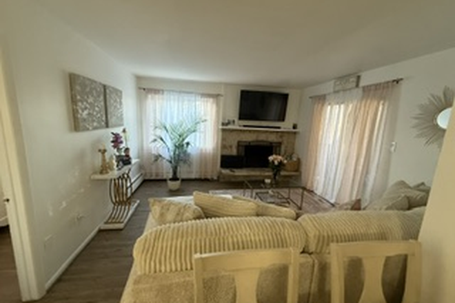 Spacious living and dining area with comfy couches, table for 4, Wi-Fi included, fireplace, and private balcony. - Cozy Private Room Near Denver – Utilities Included Condo