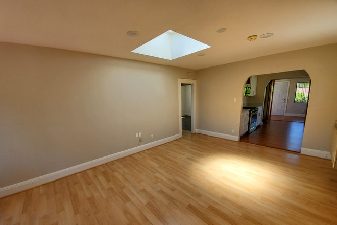Living Room with Skylight - 2BD/1BA Home with Bonus Room & Parking — Walkable Dimond District