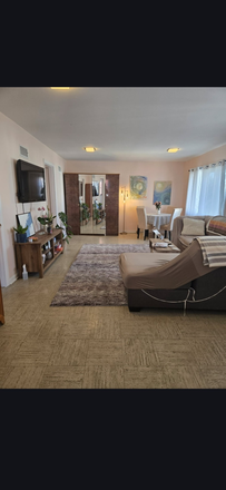 Living room - 2-Bedroom Apartment for Rent – Available July 1 1,100 sq ft, furnished living/dining room, 50-inch T