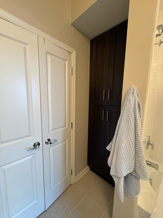 Bathroom storage cabinet, floor to ceiling. - The Fitzgerald UB Midtown Apartments