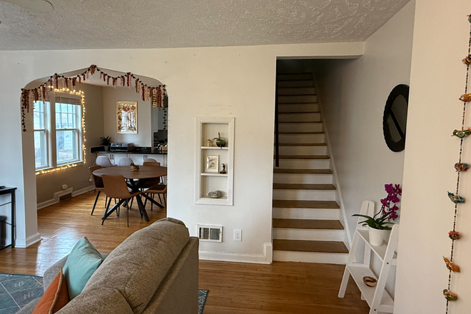 Living room and upstairs stairs - Bright and Cozy Duplex Close to Campus Duplex