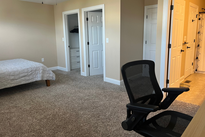 Alternate view of front bedroom - 2 closets and doors to hall and bathroom - Large primary bedroom w/private bathroom available in luxury furnished townhouse including utilities