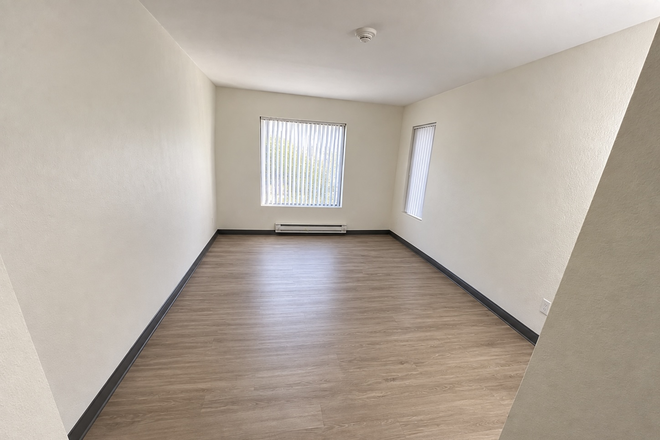 Bedroom; Used AI to only remove my personal furniture.  Two windows and a wall heater.  Outlets on each wall.  Closet on wall not visible. - Graduate Housing On Campus; Sublet.  Graduate Students only.  Male only. Apartments