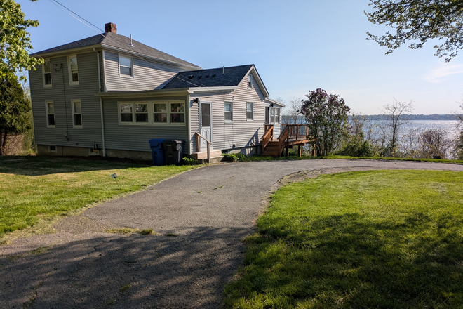 Front of house coming down driveway - Family house on bike path with water view.   Rental by month.  No summers, no Christmas vacation.