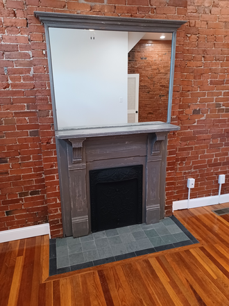 Fireplace, mantle with mirror. Slate tile - Grove Townhouse Apartment