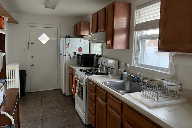 kitchen looking towards back door - Charming first floor apt. in residential neighborhood, walking distance to train/Suburban Square.
