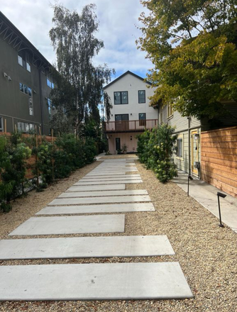 Driveway leading up to the property - Light-filled 2 bed/1.5 bath townhouse with balcony