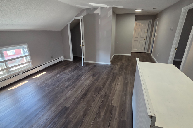 Living room area - SPEND A LITTLE FOR A LOT! First month free - MOVE IN WITH JUST LAST MONTH'S RENT! Apartments