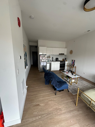 Living space/Kitchen - Uptown Studio Apartments
