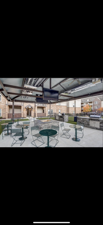 Outdoor grill and fireplace - The Lodges of East Lansing Apartments