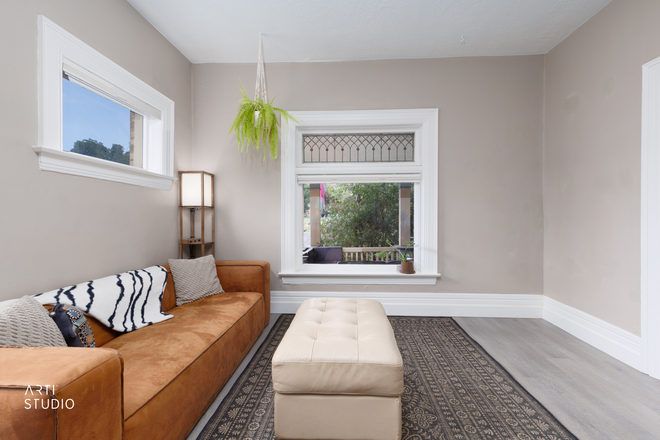 The home's original stained glass, a historic detail that casts warm light across the living space. - Furnished 2BR/2BA, 6 Blocks to Campus, Both Ensuite, Utilities Included, Academic-Year Lease Apartments