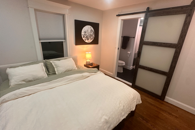 master bedroom - Furnished room in newly constructed 3BR, 4 bath home w HOT TUB, grill, screening room, and 2 decks