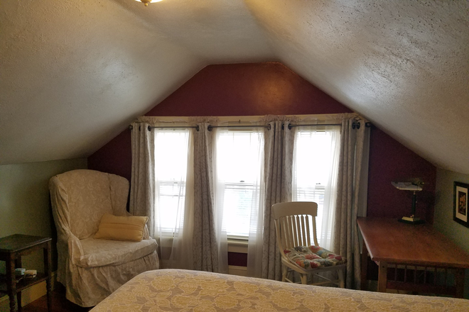 Windows, desk, and arm chair - Large furnished room on quiet dead end street