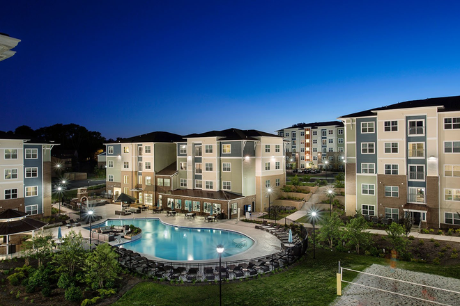 Pool, volleyball, grill area behind leasing office - The Edge Townhome (D5 Floorplan)