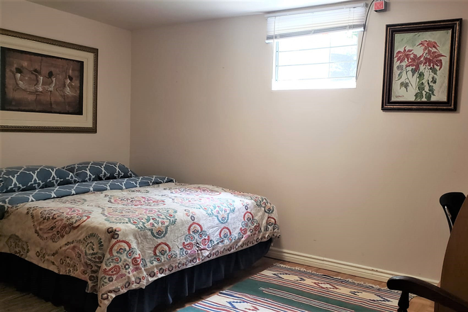Large bedroom with queen size bed - Fully Furnished Bright Two Level , Two Bedroom Apartment With WiFi And Laundry